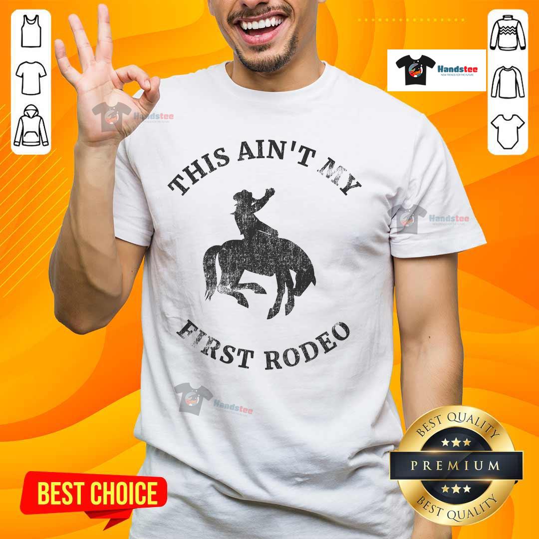 Alt Text: Awesome This Ain't My First Rodeo Bronc Horse Riding Cowboy T-Shirt featuring a bold graphic design for rodeo fans.