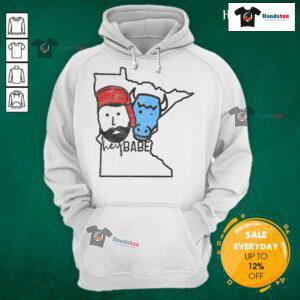 Cute Minnesota babe wearing a Paul Bunyan hoodie, showcasing local style and charm in a cozy outdoor setting.