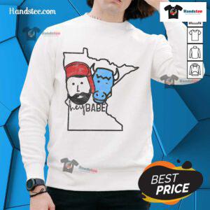Alt Text: Cute Minnesota babe wearing a Paul Bunyan sweatshirt, showcasing cozy style and state pride in a vibrant setting.