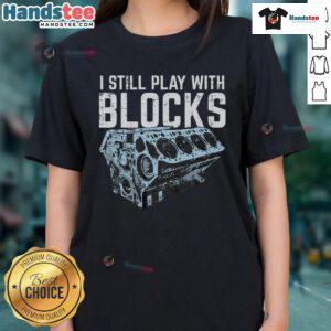 Funny mechanic t-shirt featuring 'I Still Play With Blocks' design, perfect for car lovers and humor enthusiasts.