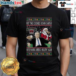Funny Christmas T-Shirt featuring Santa with 'Put The Cookies Down, We're Making America Healthy Again' slogan.
