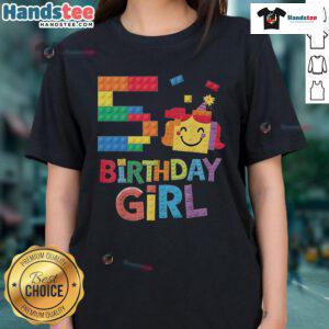 5-year-old girl in a 'Good Master Builder' tee, happily playing with brick blocks at her birthday celebration.