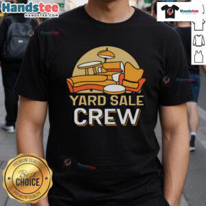 Good yard sale crew seller showcasing colorful T-shirts for sale at a vibrant community yard sale event.