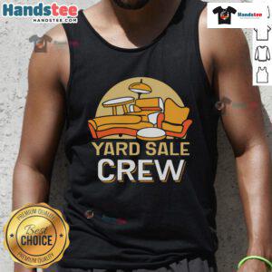 Good yard sale crew seller showcasing colorful tank tops at a vibrant outdoor market event.