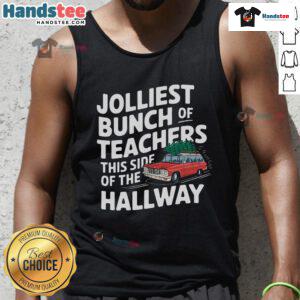 Cheerful teachers wearing 'Top Jolliest Bunch of Teachers This Side of the Hallway' Christmas tank tops, spreading holiday joy.