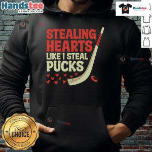 Alt Text: Cute hockey player hoodie design featuring Funny Stealing Hearts Like I Steal Pucks text for hockey fans.