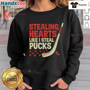 Funny stealing hearts like I steal pucks sweatshirt design featuring a cute hockey player graphic, perfect for fans.
