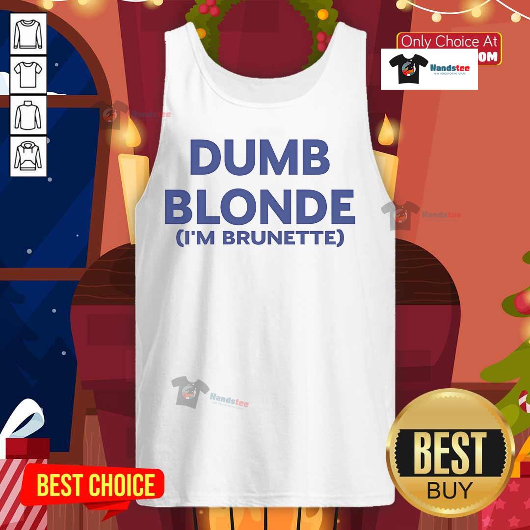 Brunette wearing a 'Nice Dumb Blonde' tank top, showcasing a playful fashion statement with a confident smile.