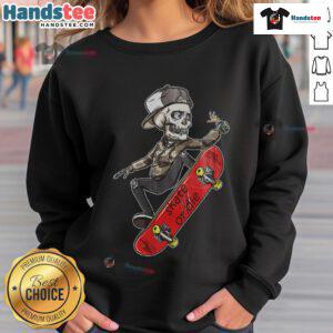 Skateboarder in a 'Skate or Die' sweatshirt, featuring a skeleton skater design, showcasing urban skate culture.