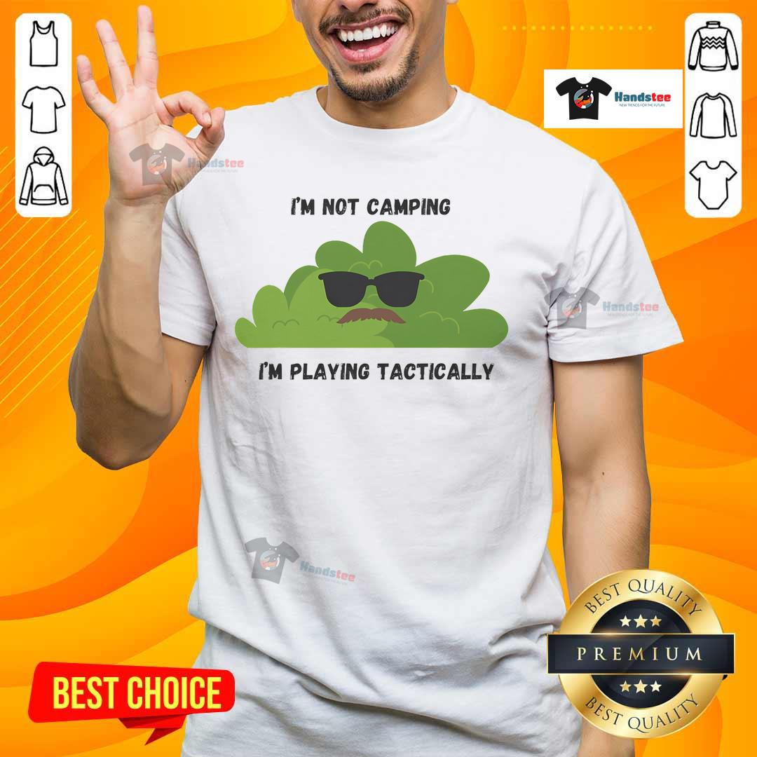 Alt Text: Funny I'M Not Camping I'M Playing Tactically Cool Bush T-Shirt design with playful graphics and bold text.