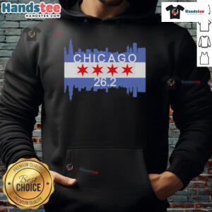 Runner in Chicago flag hoodie crossing finish line at 26.2-mile marathon, showcasing determination and athletic spirit.