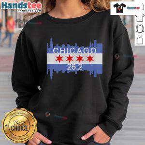 Runner in a Chicago flag sweatshirt completing a 26.2-mile marathon, showcasing athletic spirit and city pride.