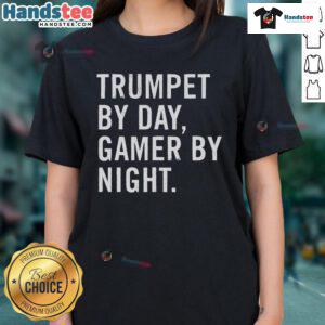 Funny trumpet musician wearing a tee that says 'Trumpet by day, gamer by night' showcasing a playful musical theme.