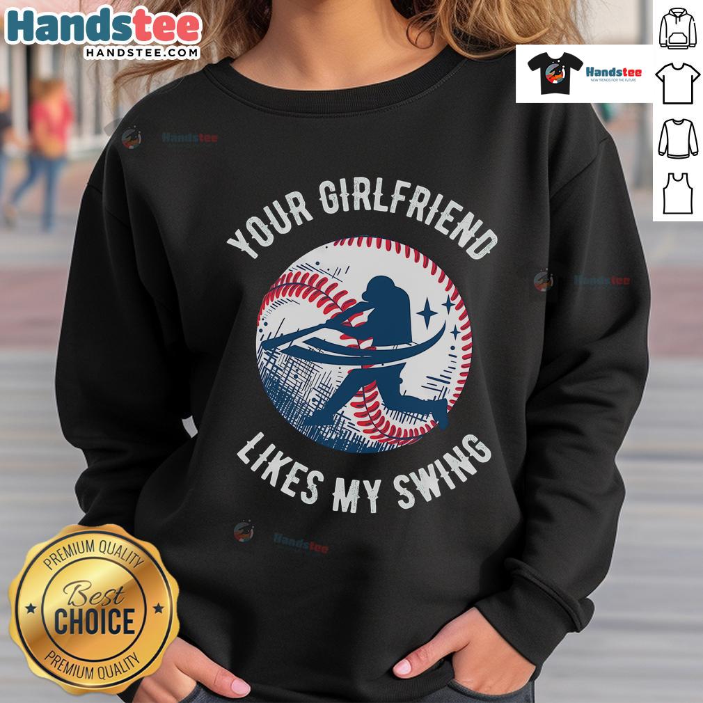 Funny Your Girlfriend Likes My Swing baseball sweatshirt worn by a smiling person at a baseball field, showcasing humor.