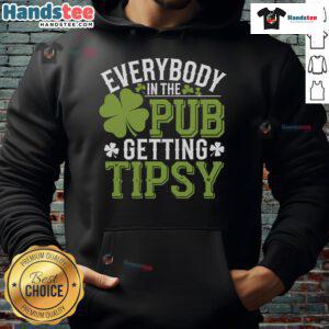 Group of friends enjoying St. Patrick's Day in a pub, wearing a 'Good Everybody' hoodie and celebrating with drinks.