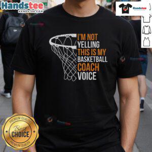 Basketball coach wearing 'Not Yelling, This Is My Coach Voice' T-shirt, emphasizing a fun and motivational coaching style.