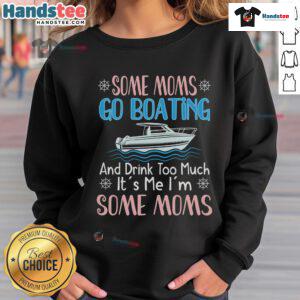 Mom wearing a 'Nice Moms Boating' sweatshirt, steering a pontoon boat, showcasing her captain skills on the water.