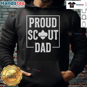 Scouting dad in a cozy hoodie enjoying camping in the wilderness with scouts, showcasing a love for outdoor adventure.