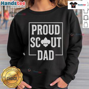 Scouting dad wearing a cozy sweatshirt in the wilderness, enjoying a camping trip with his scout kids.