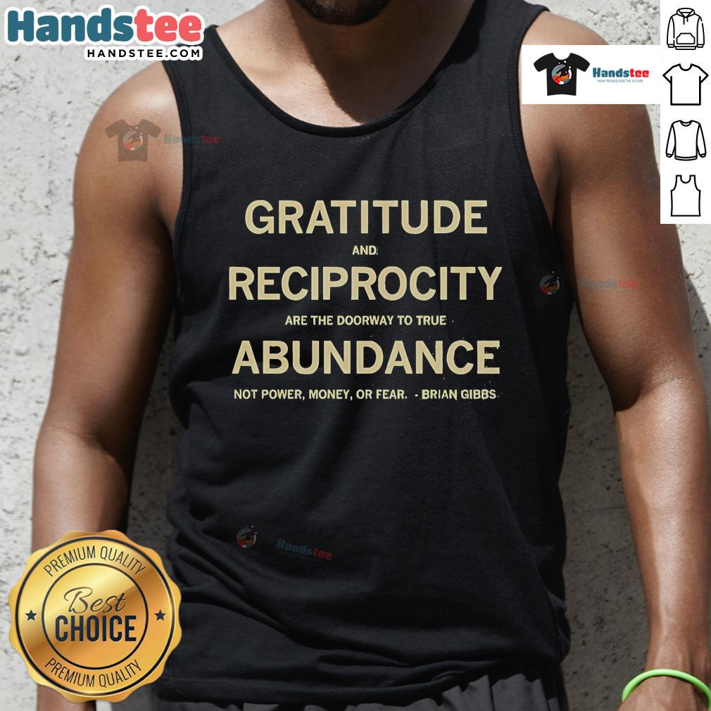 Brian Gibbs wearing a tank top with 'Gratitude and Reciprocity Are the Doorway to True Abundance' slogan.