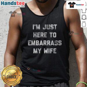 Funny workout tank top reading 'I'm just here to embarrass my wife, husband, dad' perfect for fitness lovers and family humor.