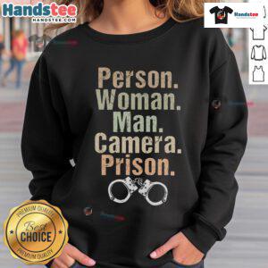 Funny person wearing a prison sweatshirt poses for the camera with a man, showcasing a playful and humorous vibe.