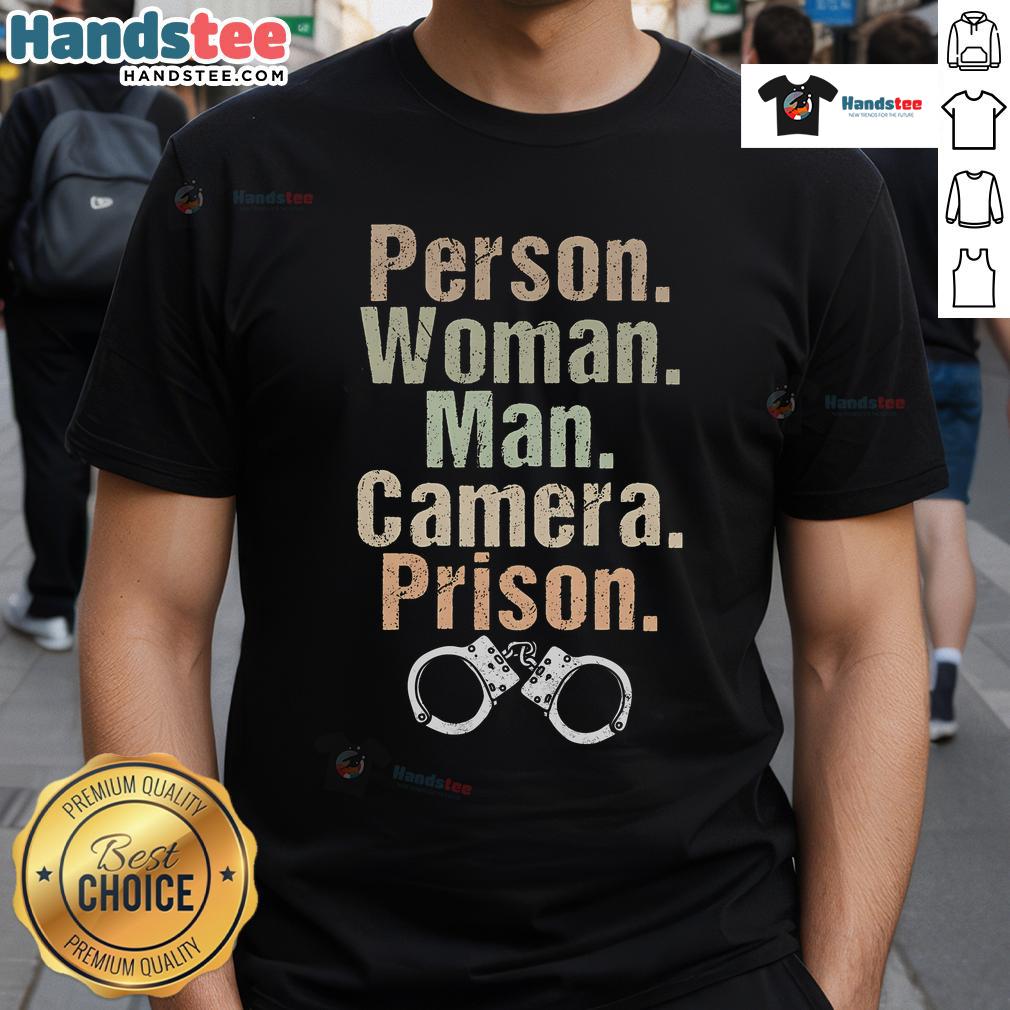 Funny person wearing a prison-themed T-shirt poses with a man and a camera, showcasing unique style and humor.