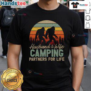 Couple wearing 'Good Bigfoot Camping Husband And Wife Partners For Life' T-Shirt, showcasing their love for adventure and Bigfoot.