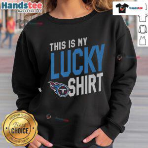 Alt Text: Fan wearing a lucky sweatshirt featuring the Tennessee Titans logo at a game, showcasing team spirit and pride.