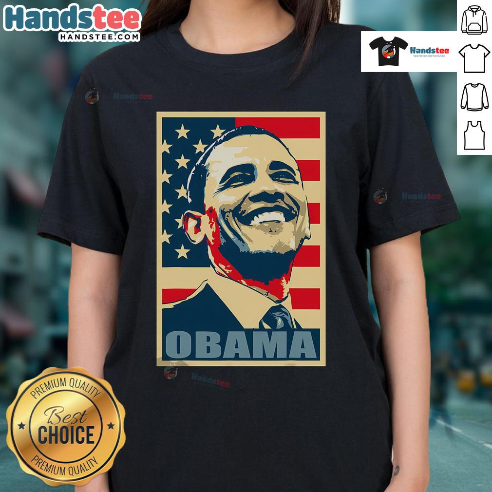 Alt Text: Happy Barack Obama, 44th President, wearing a ladies tee with American flag, representing Democrat pride.
