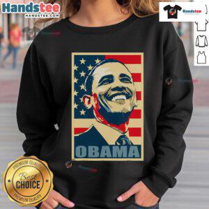Happy Barack Obama wearing a 44th President sweatshirt with an American flag, representing his Democratic legacy.