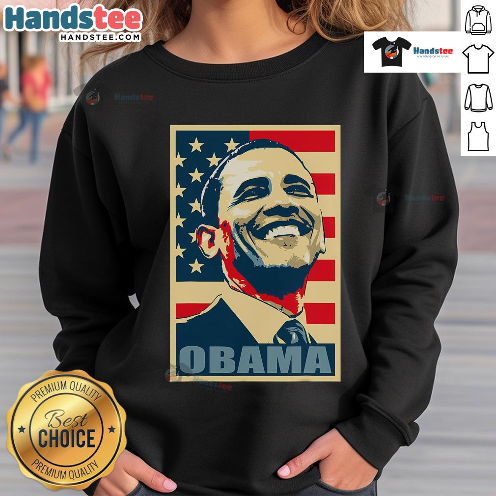 Happy Barack Obama wearing a 44th President sweatshirt with an American flag, representing his Democratic legacy.