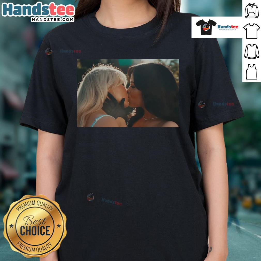 Sabrina Carpenter and Jenna Ortega share a kiss in a stylish 'Kiss and Murder' ladies tee, showcasing their vibrant fashion.
