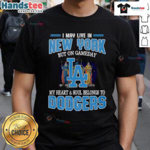 Person wearing 'I May Live In New York But On Gameday My Heart And Soul Belongs To Dodgers' T-shirt at a baseball game.