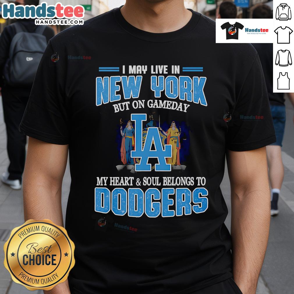 Person wearing 'I May Live In New York But On Gameday My Heart And Soul Belongs To Dodgers' T-shirt at a baseball game.