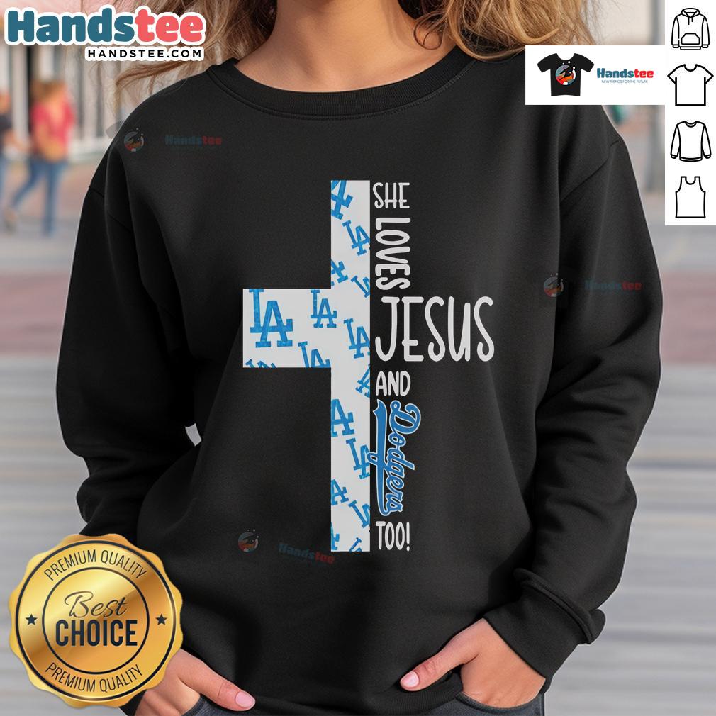 Cozy sweatshirt featuring 'She Loves Jesus and Los Angeles Dodgers Too' design, perfect for fans of faith and baseball.