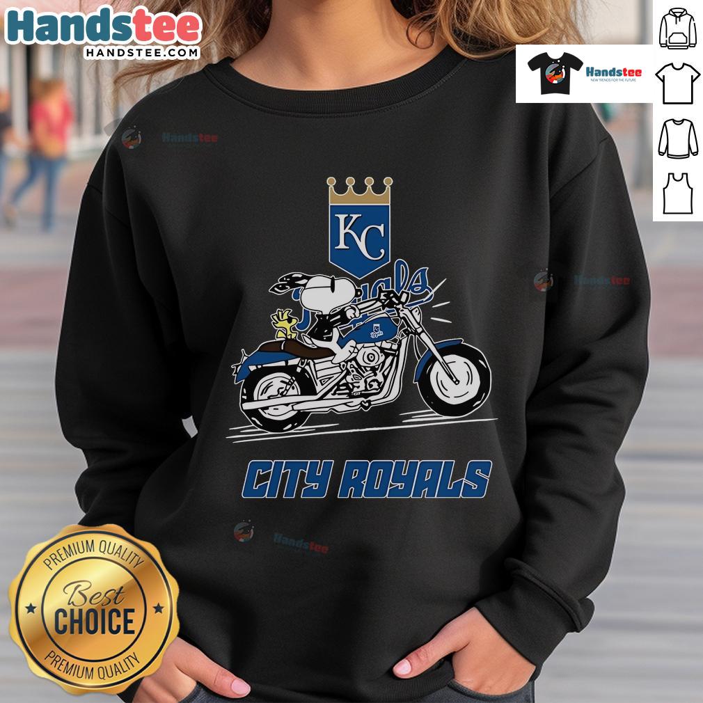 Snoopy and Woodstock driving a motorbike, featured on a Kansas City Royals sweatshirt design.
