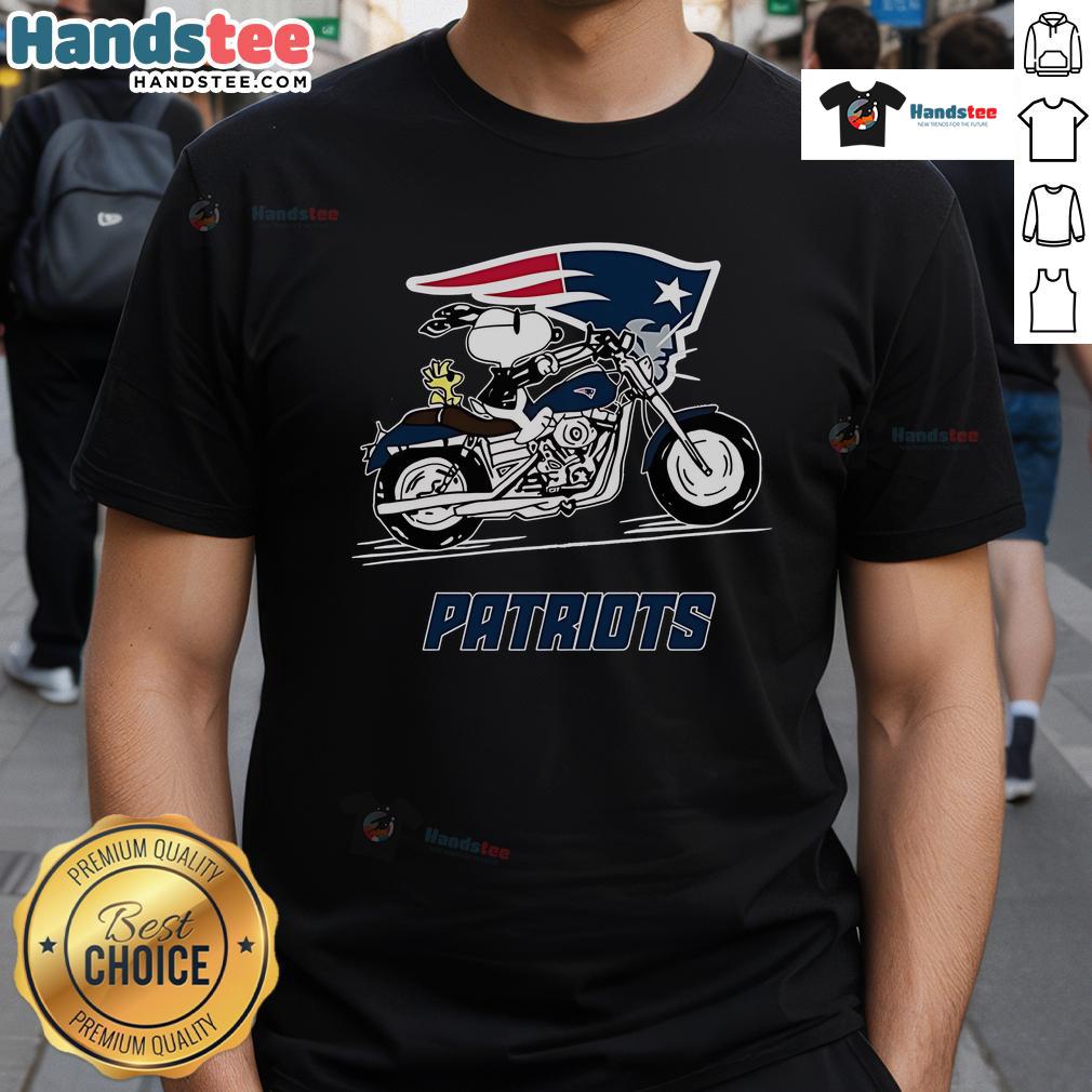 Alt Text: Snoopy and Woodstock riding a motorbike on a New England Patriots t-shirt, showcasing playful team spirit.
