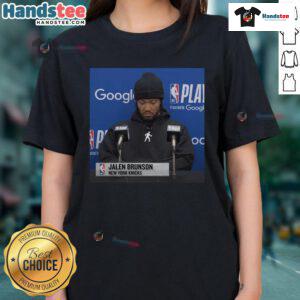 Alt Text: Official Jalen Brunson press conference ladies tee featuring team logo and stylish design for fans.