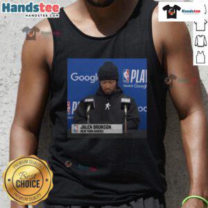 Jalen Brunson at an official press conference wearing a stylish tank top, showcasing his signature style and charisma.
