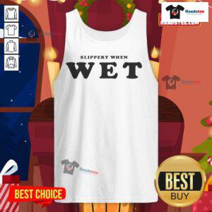 Renee Rapp wearing a 'Slippery When Wet' tank top, showcasing her stylish look and vibrant personality on stage.