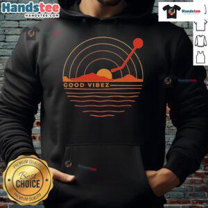 Good Vibez Record sunset hoodie worn by a person against a vibrant sunset backdrop, showcasing relaxed streetwear style.