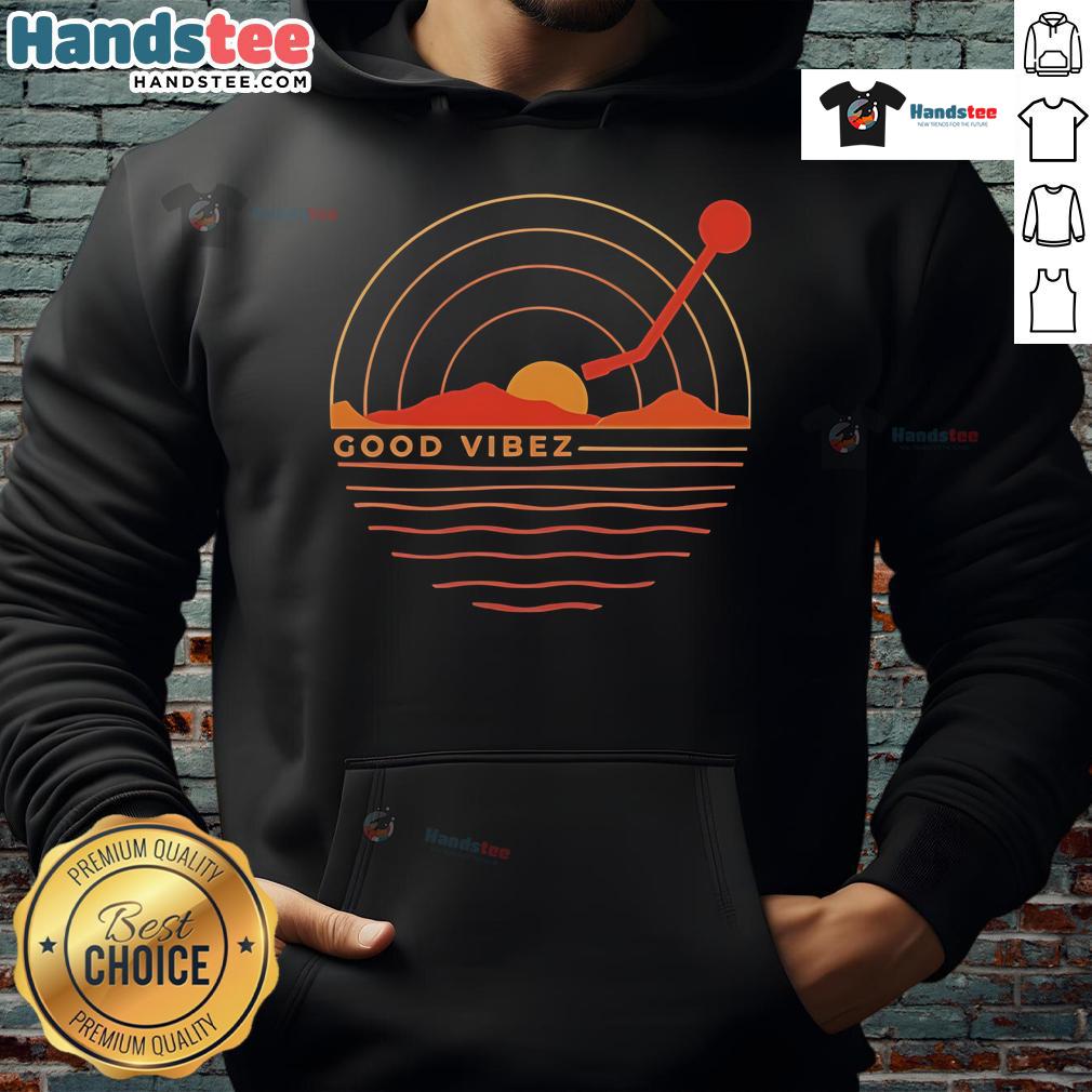 Good Vibez Record sunset hoodie worn by a person against a vibrant sunset backdrop, showcasing relaxed streetwear style.