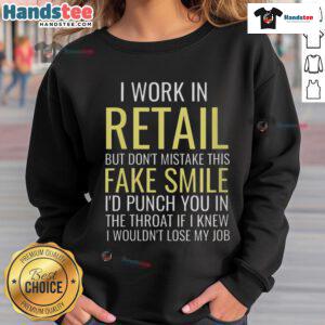 Alt Text: Funny 'I Work In Retail' sweatshirt with fake smile graphic, perfect for retail workers showcasing humor and personality.