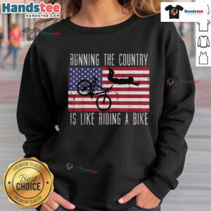 Funny running the country is like riding a bike sweatshirt, featuring humorous graphics and bold text design.
