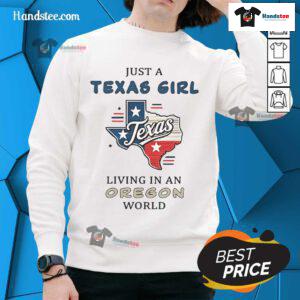 Alt Text: Cozy 'Good Just A Texas Girl Living In An Oregon World' sweatshirt displayed on a rustic wooden background.