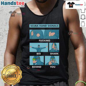 Scuba diver showing hand signal for 'big shark behind you' while wearing a tank top, highlighting important dive safety.