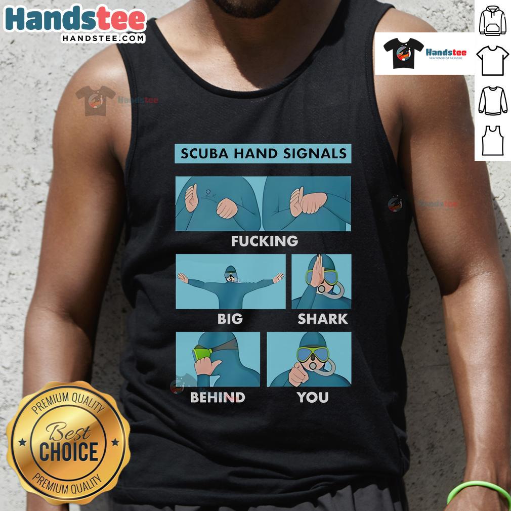Scuba diver showing hand signal for 'big shark behind you' while wearing a tank top, highlighting important dive safety.