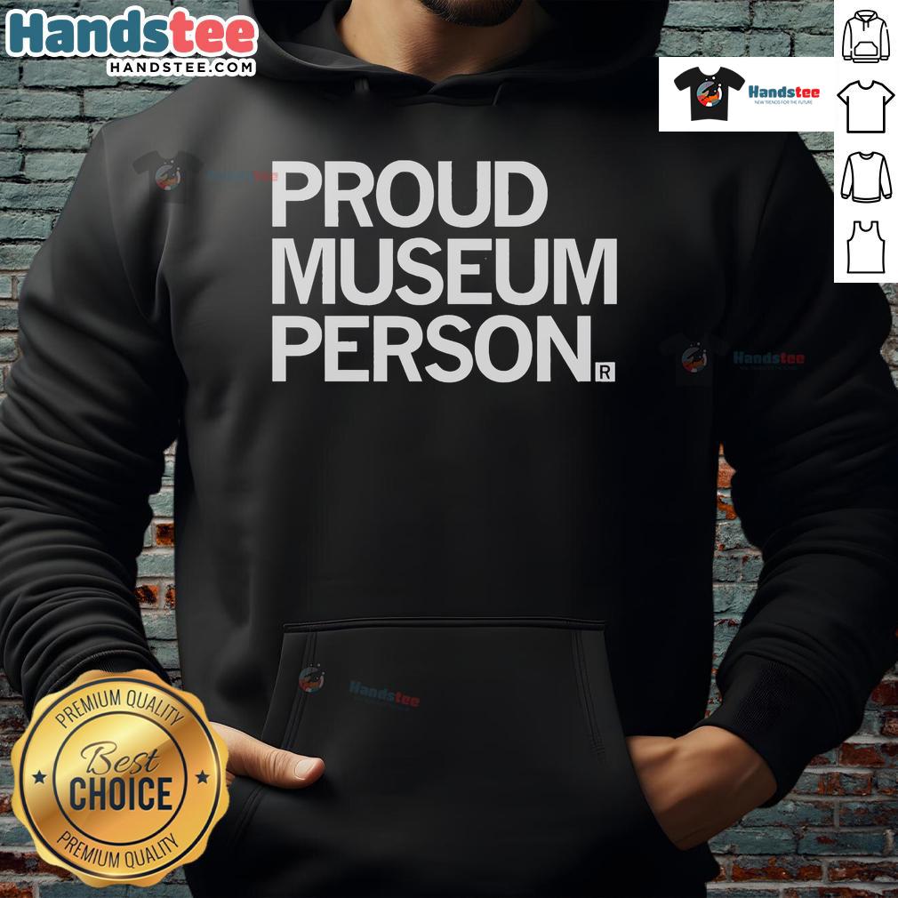 Proud museum staff member wearing a cozy hoodie, showcasing a friendly smile and passion for art and culture.