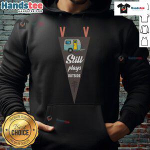Nice still plays outside RV camper wearing a cozy camping hoodie, enjoying nature and outdoor adventures.